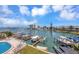 Overhead view of a community waterfront pool, surrounded by lounge chairs and boat docks at 234 Dolphin Pt # 1, Clearwater Beach, FL 33767