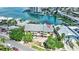 Aerial of home showing yellow exterior, metal roof and well maintained landscaping at 234 Dolphin Pt # 1, Clearwater Beach, FL 33767