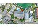 Birds eye view of a home featuring a pristine pool, private boat dock, and lush landscaping at 234 Dolphin Pt # 1, Clearwater Beach, FL 33767