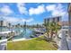 Waterfront home featuring a backyard oasis with a boat dock and a picturesque view of the serene harbor at 234 Dolphin Pt # 1, Clearwater Beach, FL 33767