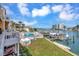 Inviting backyard with a private pool, lush green lawn, and a boat dock offering direct access to the water at 234 Dolphin Pt # 1, Clearwater Beach, FL 33767