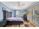 Bedroom with hardwood floors, slider to balcony, and a ceiling fan at 234 Dolphin Pt # 1, Clearwater Beach, FL 33767
