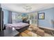 Comfortable bedroom with blue accents and a ceiling fan at 234 Dolphin Pt # 1, Clearwater Beach, FL 33767