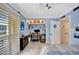 Bright bedroom featuring a built-in desk, light blue walls, and wood-look tile flooring at 234 Dolphin Pt # 1, Clearwater Beach, FL 33767