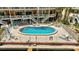 Relaxing community pool area with lounge chairs and well-maintained landscaping at 234 Dolphin Pt # 1, Clearwater Beach, FL 33767