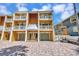 Charming multi-story townhouse featuring balconies, garages, and a colorful exterior at 234 Dolphin Pt # 1, Clearwater Beach, FL 33767