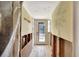 Hallway with distressed walls and open studs, decorated with beach-themed decor at 234 Dolphin Pt # 1, Clearwater Beach, FL 33767