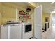 Convenient laundry area with new washer/dryer, shelving, and storage, with hallway access at 234 Dolphin Pt # 1, Clearwater Beach, FL 33767