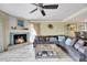 Spacious living area features a fireplace, a ceiling fan, and comfortable sofa with decorative pillows at 234 Dolphin Pt # 1, Clearwater Beach, FL 33767