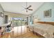 Bright main bedroom featuring water views, hardwood floors, and a ceiling fan at 234 Dolphin Pt # 1, Clearwater Beach, FL 33767