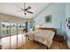 Light-filled bedroom with vaulted ceiling, slider to balcony, and waterfront views at 234 Dolphin Pt # 1, Clearwater Beach, FL 33767