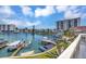 Picturesque waterfront view with boat docks, lush landscaping and clear blue skies at 234 Dolphin Pt # 1, Clearwater Beach, FL 33767