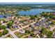 Stunning aerial view of the neighborhood with lake access, lush greenery, and nearby amenities at 2904 Pointer Pl, Seffner, FL 33584