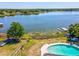 A high aerial view showcases an inviting pool and dockside area, enhancing the lakeside charm at 2904 Pointer Pl, Seffner, FL 33584