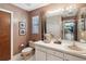 Bathroom featuring a mirror with decorative lighting, white vanity and tile flooring at 2904 Pointer Pl, Seffner, FL 33584