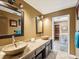 Modern bathroom with dual vessel sinks, tile countertops, and a view of the sauna at 2904 Pointer Pl, Seffner, FL 33584