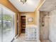 Bathroom featuring a walk-in shower, glass block accent wall and wooden wardrobe at 2904 Pointer Pl, Seffner, FL 33584