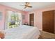 Inviting bedroom with a window letting in natural light, a ceiling fan, and a closet at 2904 Pointer Pl, Seffner, FL 33584