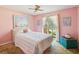 Cozy bedroom features a large window, neutral carpet, and soft pink walls at 2904 Pointer Pl, Seffner, FL 33584
