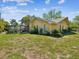 Back exterior view of the home with a backyard and screened-in patio with a pool at 2904 Pointer Pl, Seffner, FL 33584