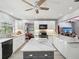 Modern kitchen with white cabinets, gray island, stainless steel appliances, marble countertops and a view to a living room at 2904 Pointer Pl, Seffner, FL 33584