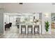 Modern kitchen with white cabinets, stainless steel appliances and an island with bar stool seating at 2904 Pointer Pl, Seffner, FL 33584