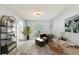 Cozy living room with a leather chair, a desk, and a view to an updated kitchen at 2904 Pointer Pl, Seffner, FL 33584