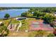 Aerial view of the community park featuring tennis courts, playground, and pavilion by the lake at 2904 Pointer Pl, Seffner, FL 33584