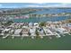 Scenic aerial view of waterfront homes with docks and boat lifts on a clear day, showcasing the coastal community at 321 Bahia Vista Dr, Indian Rocks Beach, FL 33785