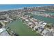 Expansive aerial view of waterfront community with boat docks and the ocean in the background on a sunny day at 321 Bahia Vista Dr, Indian Rocks Beach, FL 33785