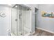 Shower stall featuring clear glass, white subway tile with a marble accent border, and shower bench at 321 Bahia Vista Dr, Indian Rocks Beach, FL 33785