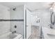 Open bathroom featuring tiled walls, marble counters, modern fixtures, and access to a tub with shower at 321 Bahia Vista Dr, Indian Rocks Beach, FL 33785