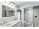 Stylish bathroom featuring double sinks, a spacious shower with marble tile, and a toilet at 321 Bahia Vista Dr, Indian Rocks Beach, FL 33785