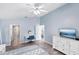 Cozy bedroom painted in light blue, featuring wood-look floors, dresser, and vanity at 321 Bahia Vista Dr, Indian Rocks Beach, FL 33785