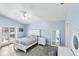 Serene bedroom with light blue walls, a ceiling fan, and access to a waterfront view at 321 Bahia Vista Dr, Indian Rocks Beach, FL 33785