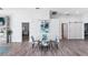 Bright dining area featuring a modern table set, stylish decor, and wood-look floors at 321 Bahia Vista Dr, Indian Rocks Beach, FL 33785