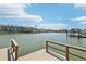 Dock featuring boat lift, water access, and views of the colorful waterfront townhomes in the community at 321 Bahia Vista Dr, Indian Rocks Beach, FL 33785