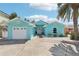 Charming turquoise home featuring a well-manicured yard and a welcoming entryway at 321 Bahia Vista Dr, Indian Rocks Beach, FL 33785