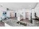 Open concept kitchen showcases an island with granite countertops and stainless steel appliances at 321 Bahia Vista Dr, Indian Rocks Beach, FL 33785