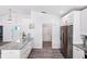 Well-lit kitchen featuring an island with granite countertops, white cabinetry, and stainless steel appliances at 321 Bahia Vista Dr, Indian Rocks Beach, FL 33785
