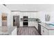 Bright kitchen with granite countertops, stainless steel appliances, and white cabinets for a modern feel at 321 Bahia Vista Dr, Indian Rocks Beach, FL 33785