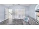 Open living room featuring a gray sofa, two closets, light blue walls, and modern decor at 321 Bahia Vista Dr, Indian Rocks Beach, FL 33785