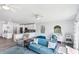 Open-concept living space with kitchen island, dining area, desk nook, and comfortable living room furniture at 321 Bahia Vista Dr, Indian Rocks Beach, FL 33785
