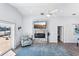 Living area with a contemporary fireplace, waterfront views, and access to the outdoor patio through sliding glass doors at 321 Bahia Vista Dr, Indian Rocks Beach, FL 33785