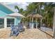 Charming patio with a tiki bar, dining area, and beautiful tropical landscaping at 321 Bahia Vista Dr, Indian Rocks Beach, FL 33785