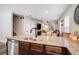 Open concept kitchen with granite countertops, stainless steel appliances and a view of the living room at 3307 E Comanche Ave, Tampa, FL 33610