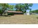 Large backyard with an enclosed back porch and shed at 39696 Meadowood Loop, Zephyrhills, FL 33542