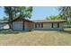 Single-story home with a manicured lawn, inviting curb appeal at 39696 Meadowood Loop, Zephyrhills, FL 33542