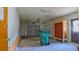 Attached garage featuring a metal roll up door, cabinet and concrete floor at 39696 Meadowood Loop, Zephyrhills, FL 33542