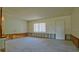 Spacious living room area with a window for natural light and potential for customization at 39696 Meadowood Loop, Zephyrhills, FL 33542